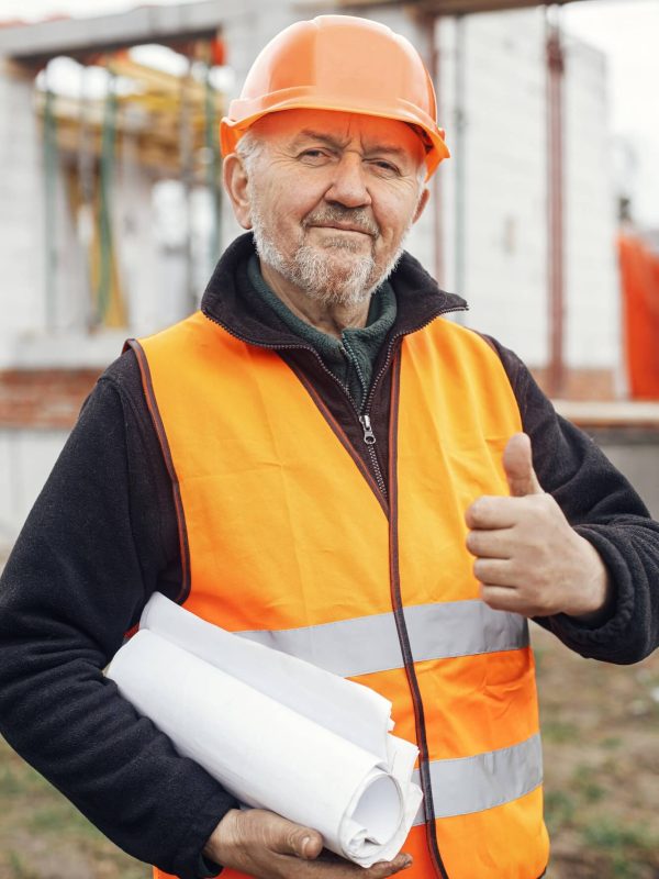 senior-man-engineer-or-construction-worker-in-hardhat-approving-building-new-house-with-blueprints-1.jpg